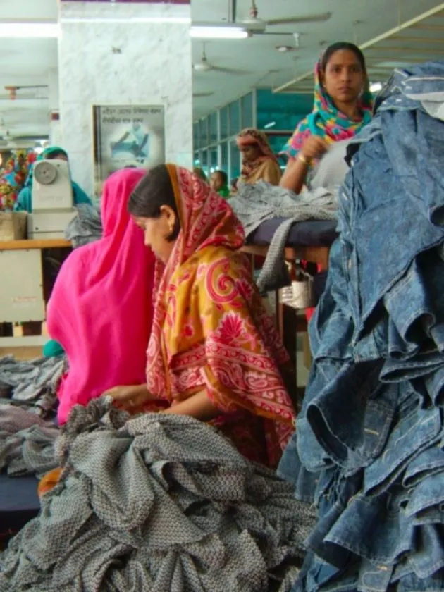 Image of garment workers with piles of clothes - Fashionscapes ethical fashion documentary