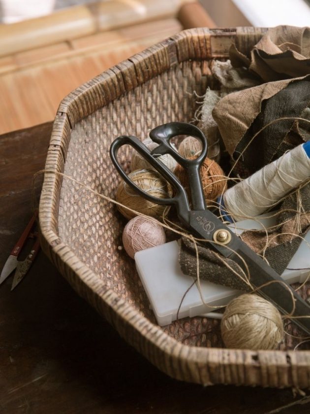 Scissors and thread in a basket for clothing repair or mending