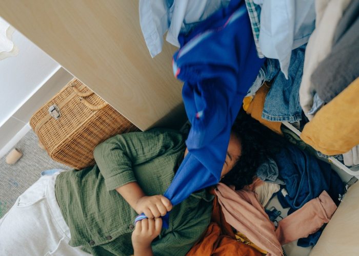 Woman with overflowing closet with eco guilt