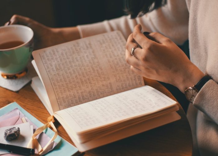 Photo of journal and cup of tea - free self care