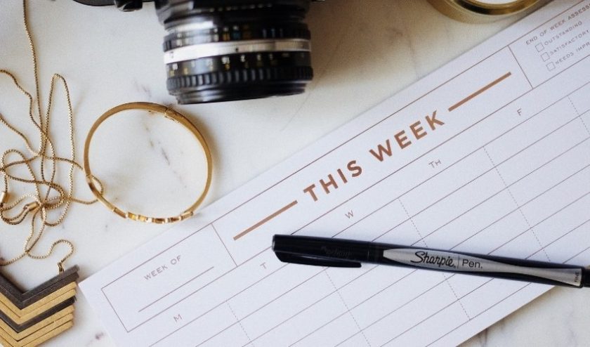 Calendar and pen with clutter in the background