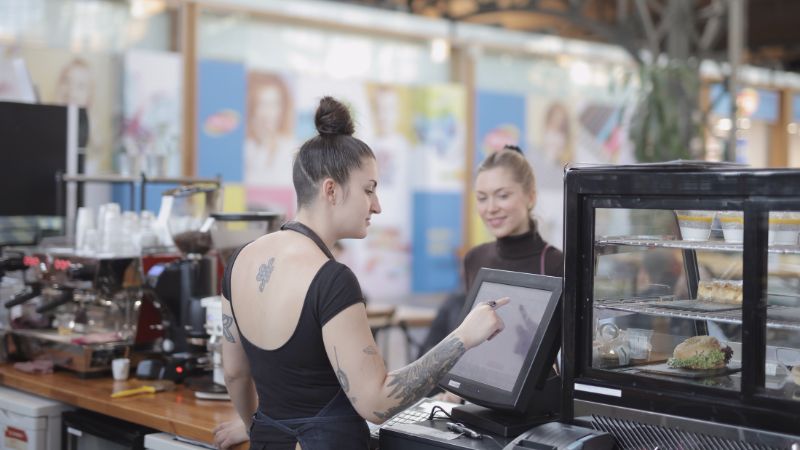 Women paying in shop - slow travel guide