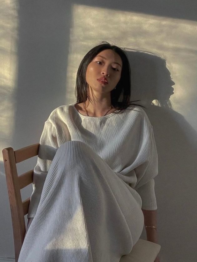 woman wearing white knit sustainable dress 