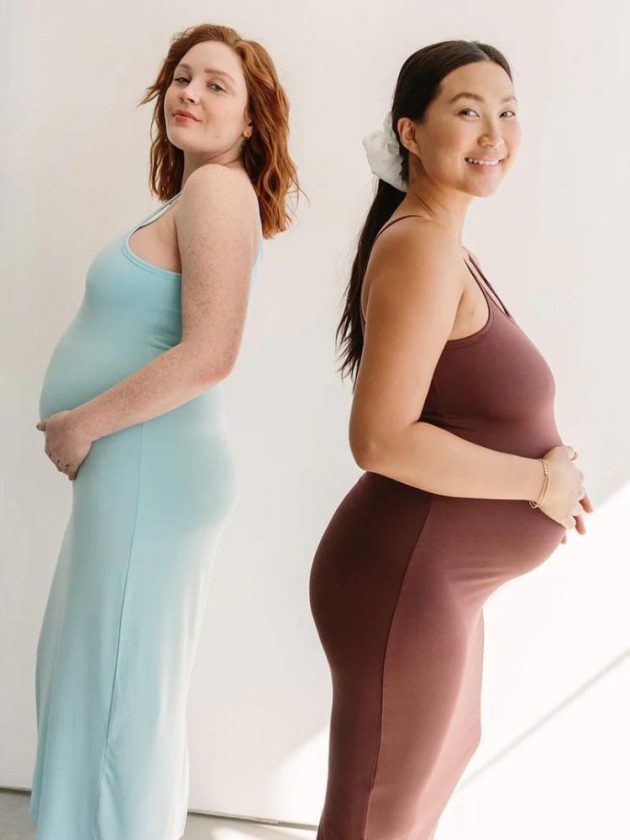 two women wearing sustainable maternity dresses from Storq