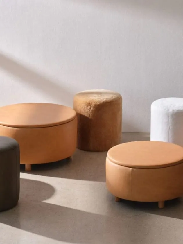 orange lather, white, black and brown stools and ottomans from The Citizenry