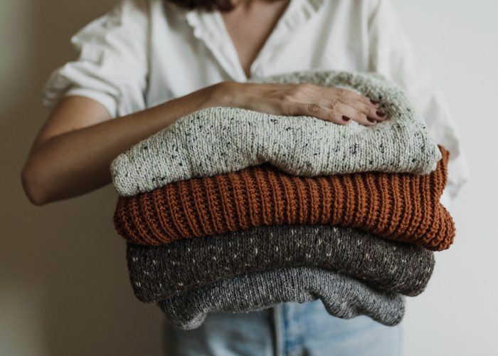 Woman holding a pile of clothing